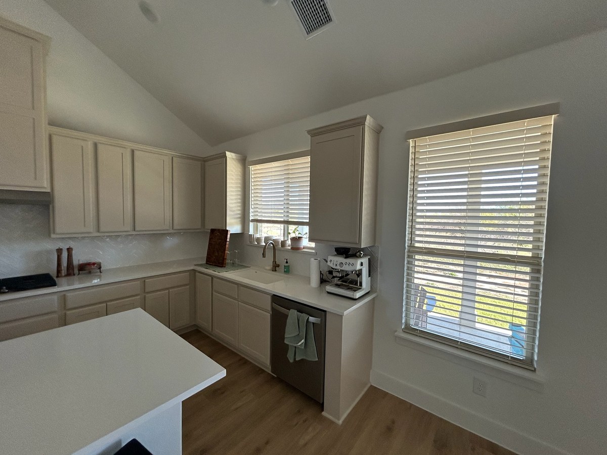 Faux wood blinds in a kitchen by Love Is Blinds Georgia