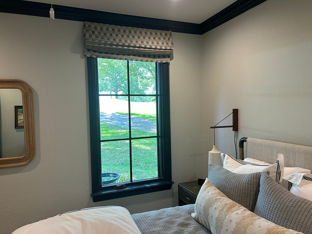 Roman shades in a bedroom by Love Is Blinds Georgia