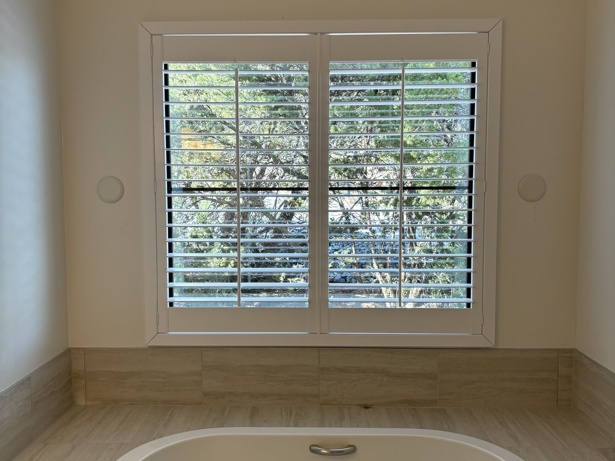 Plantation shutters in a bathroom by Love Is Blinds Georgia
