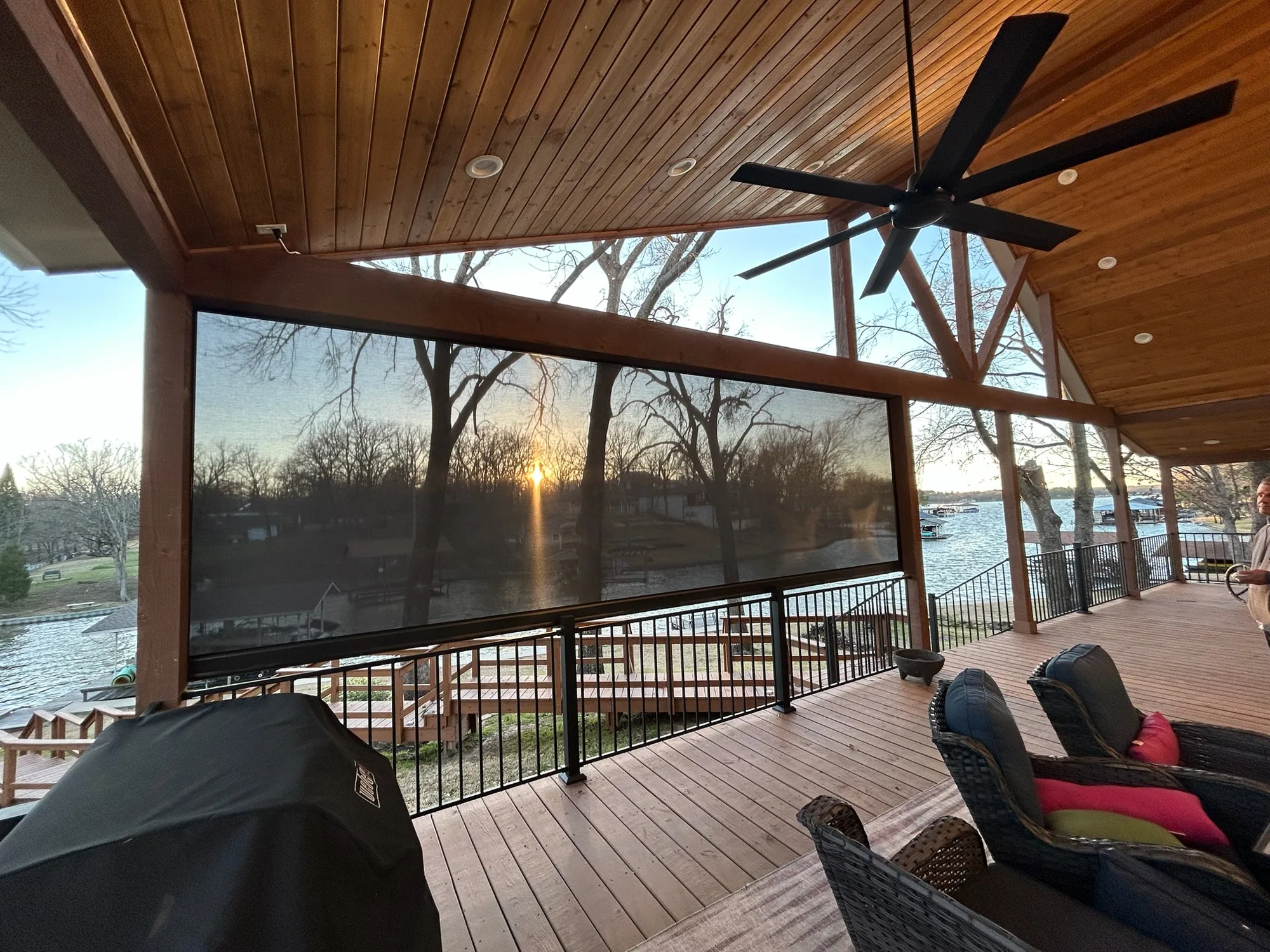 An outdoor kitchen area has exterior patio shades.